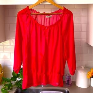 A sheer red shirt is great for this hot summer